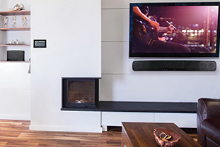 flat screen tv and speaker next to modern fireplace